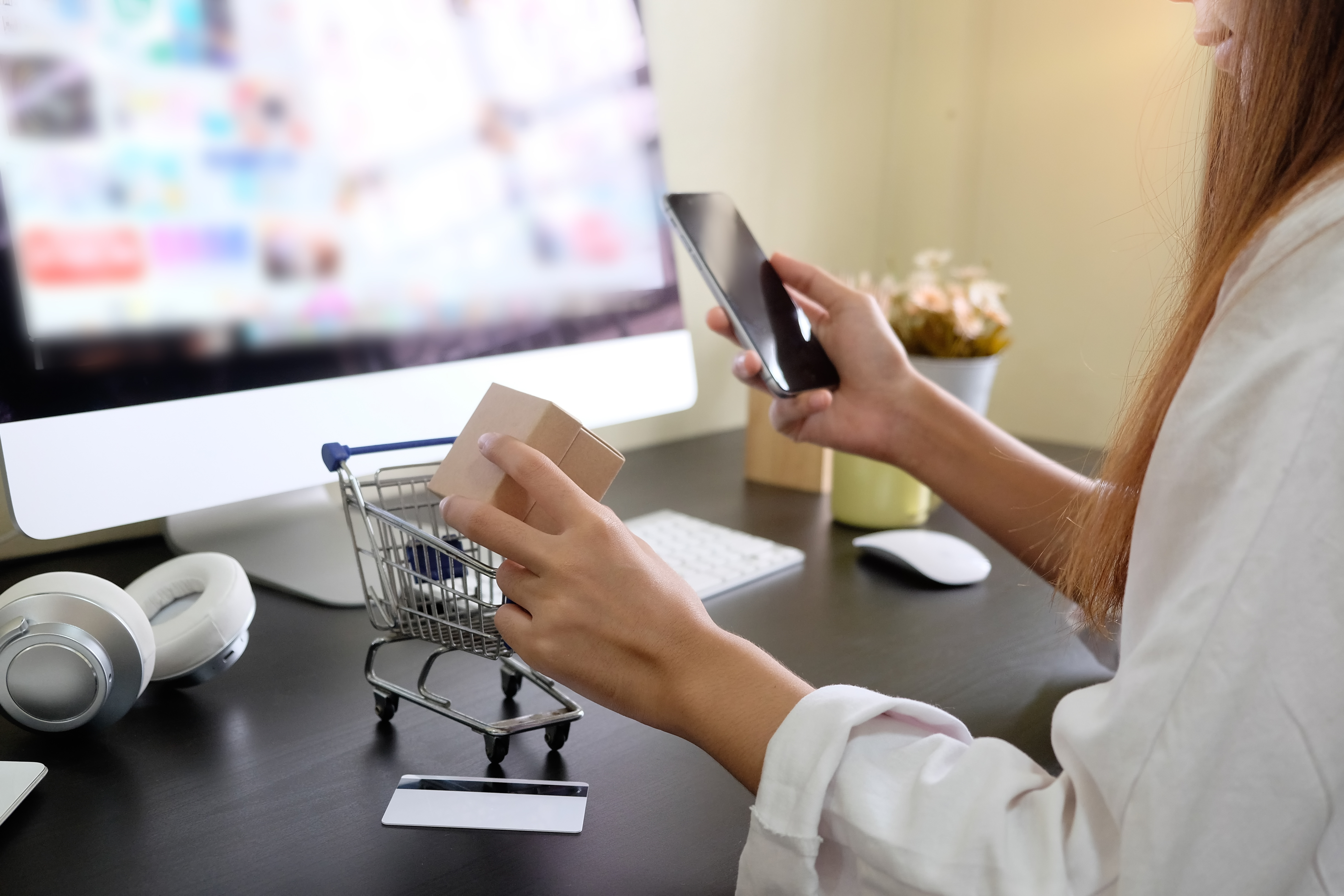 Boxes in a trolley with woman hands. Shopping online concept.