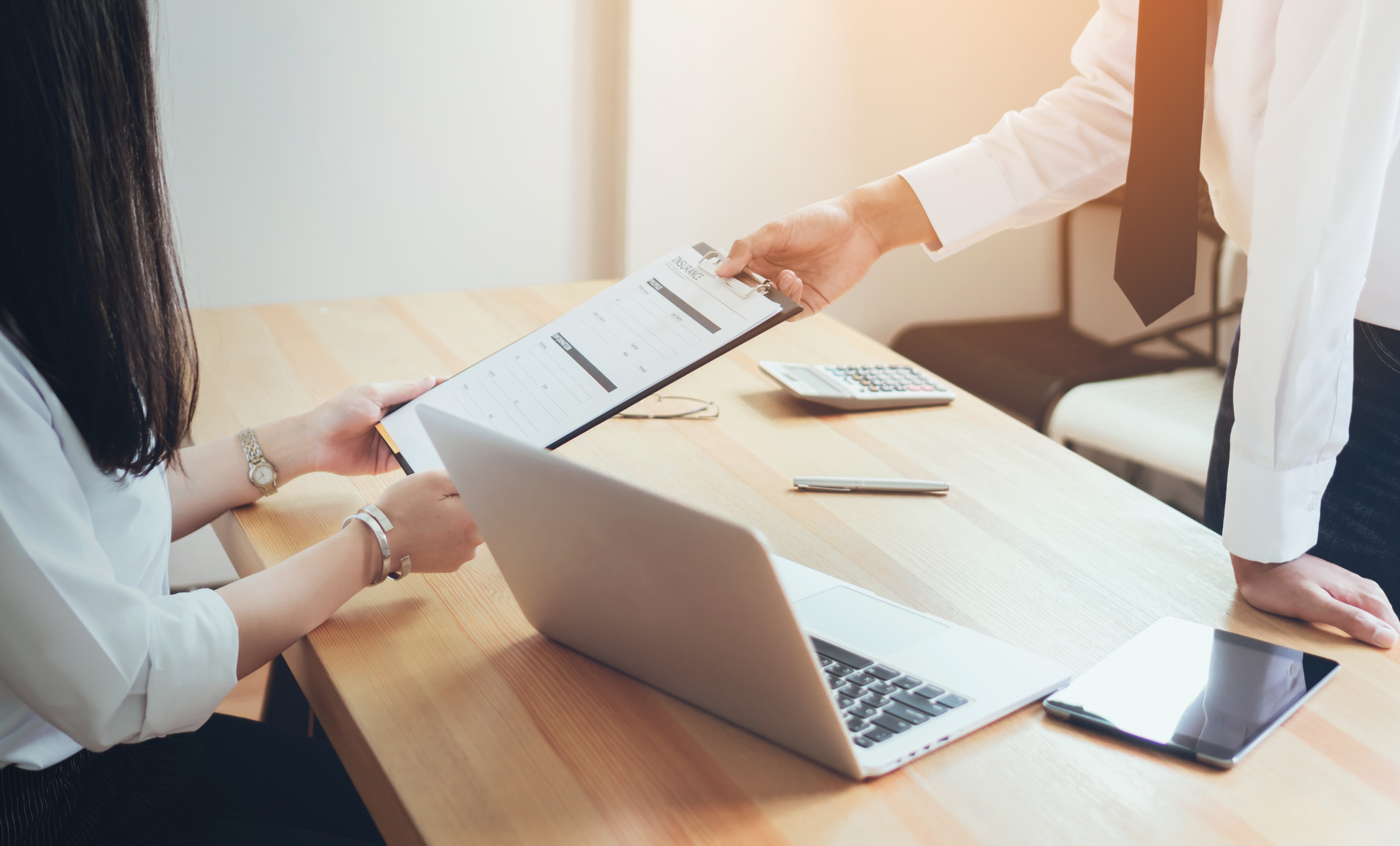 Businessman handing insurance application form